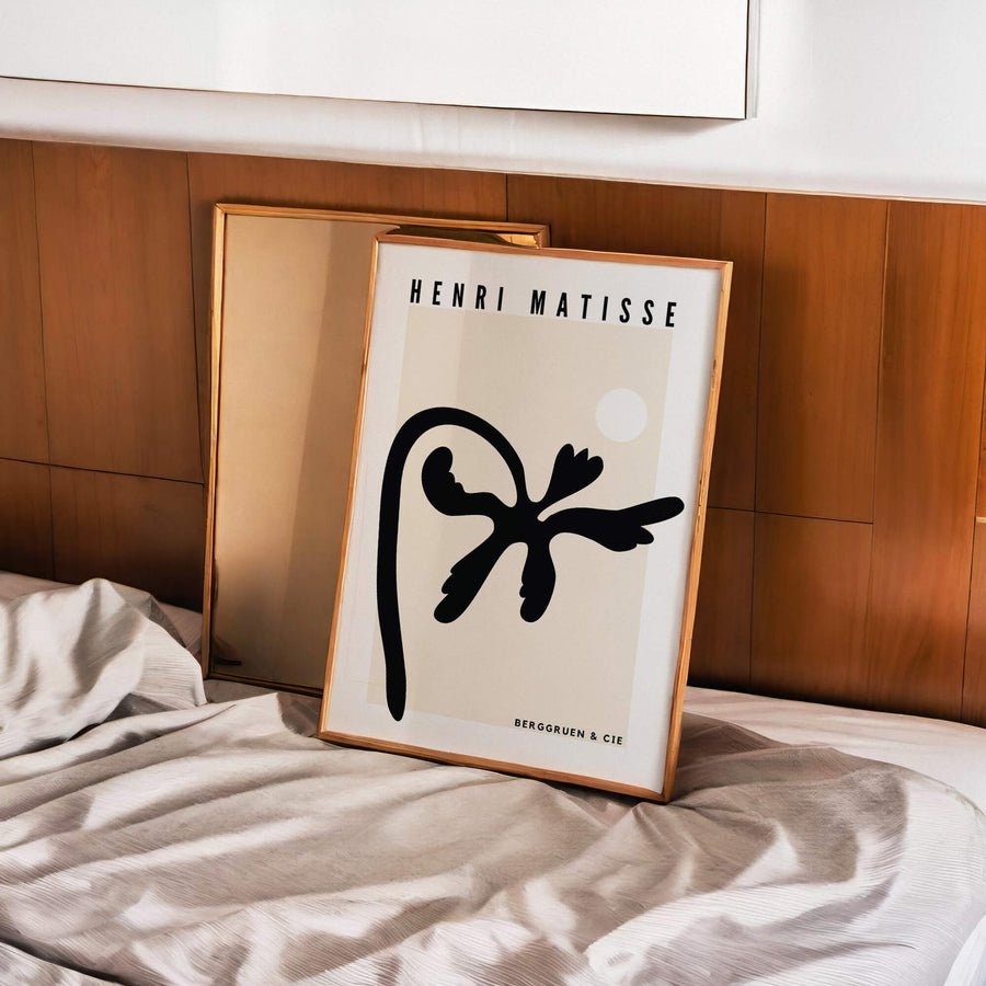 Matisse-inspired black palm abstract print featuring bold organic cut-out shapes against a neutral beige background. A modern and minimalist botanical wall art piece. Get 2PrintsFor$100 that comes with Free Shipping 🚚💫 in Australia.