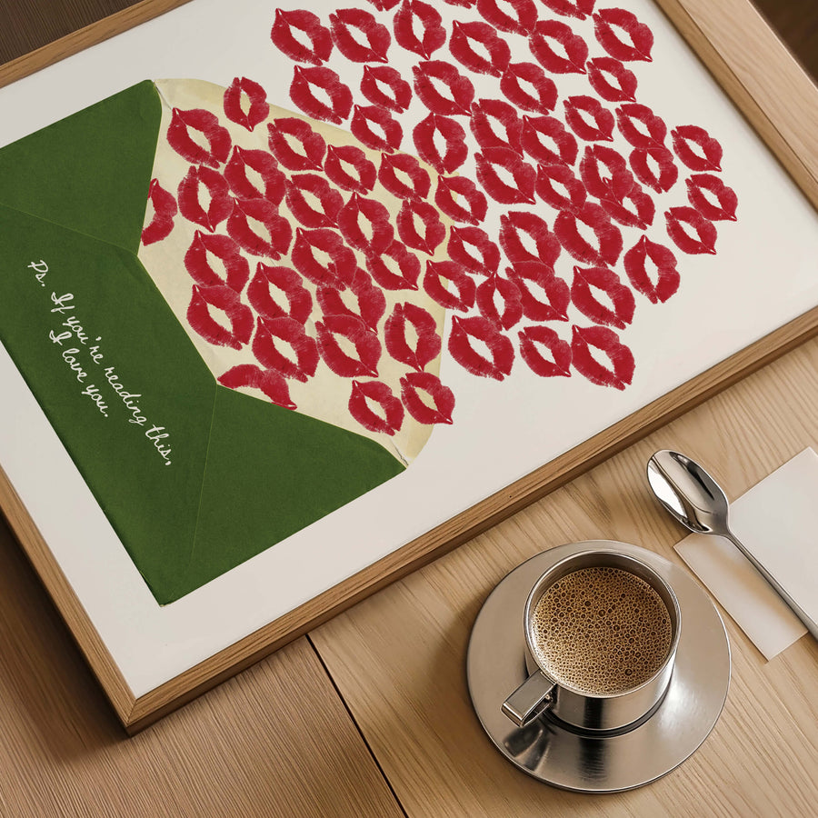 A romantic art print featuring a green envelope with red lipstick kiss marks spilling out. The handwritten text reads: 